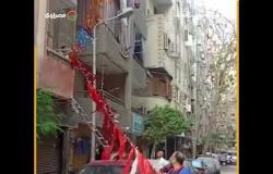 رغم الخوف من كورونا.. سكان فيصل يجهزون الشارع بزينة رمضان